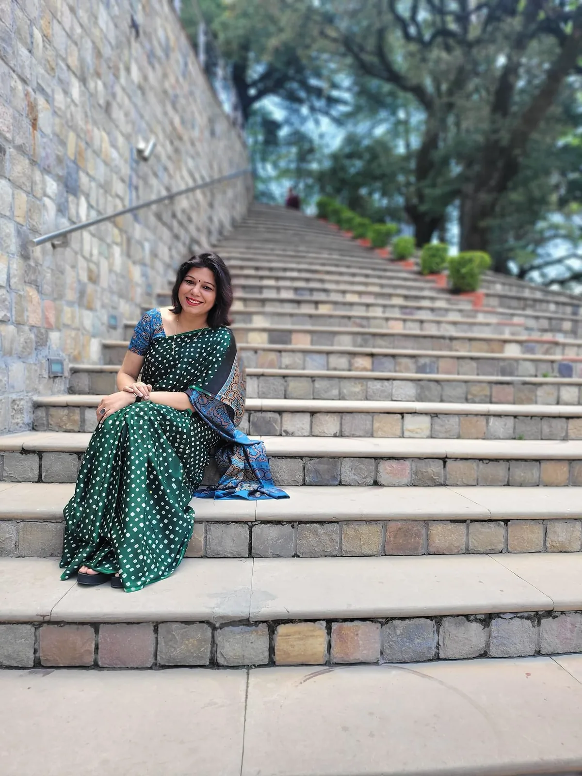 Shubhra Saxena seated on outdoor steps, from her years in the IT industry