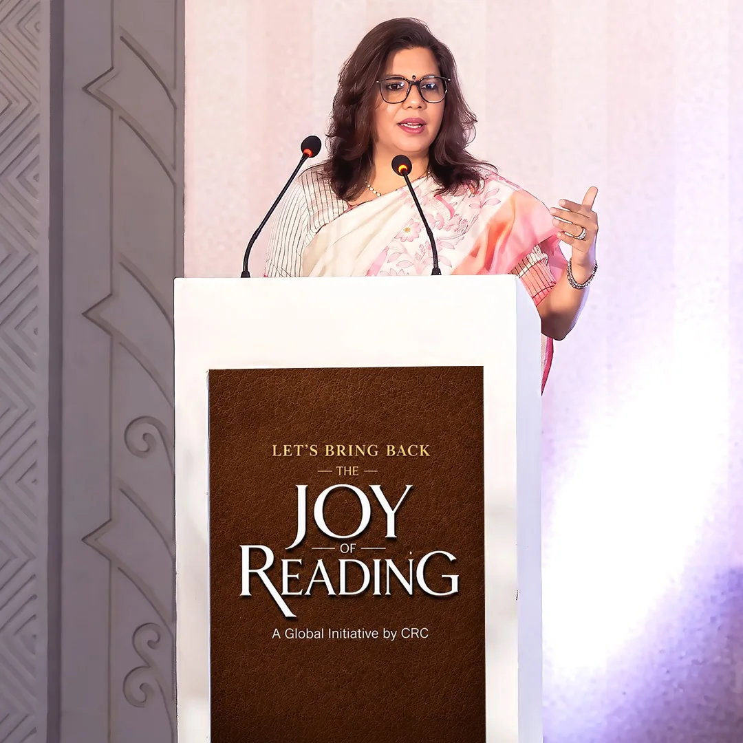 Shubhra Saxena speaking at a podium at a public engagement