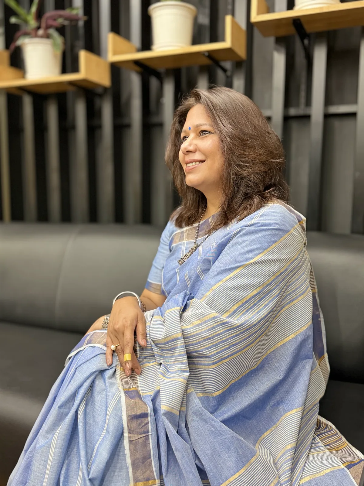 Shubhra Saxena seated, reflecting on where her story began