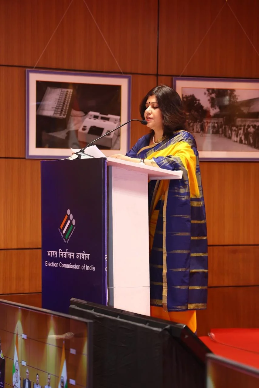 Shubhra Saxena speaking at a podium at the Election Commission of India