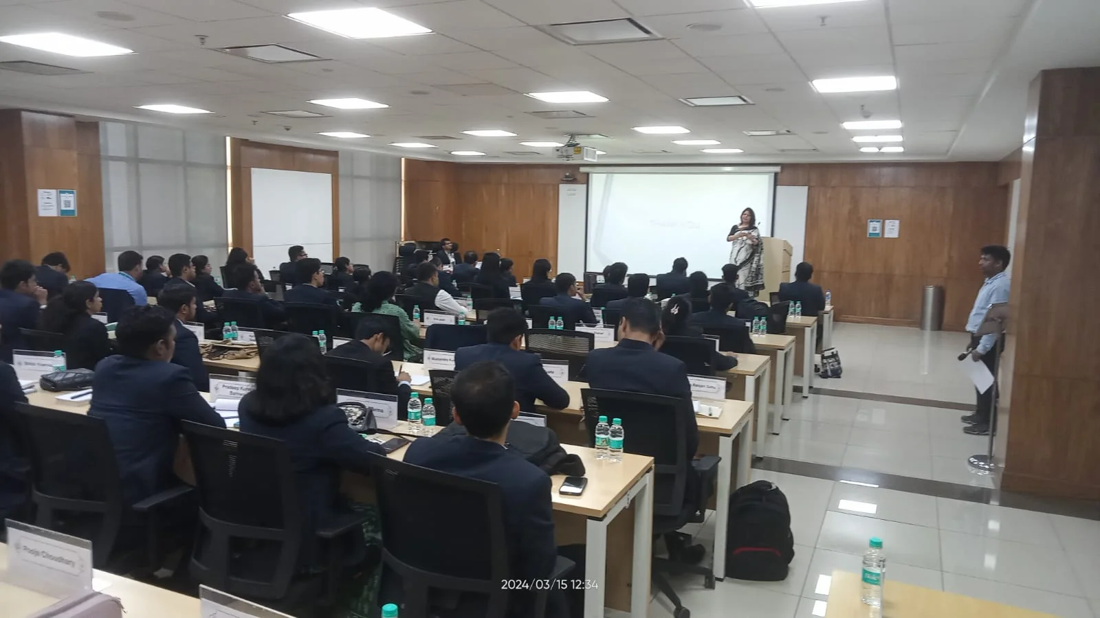 Shubhra Saxena addressing a room of professionals during a training session