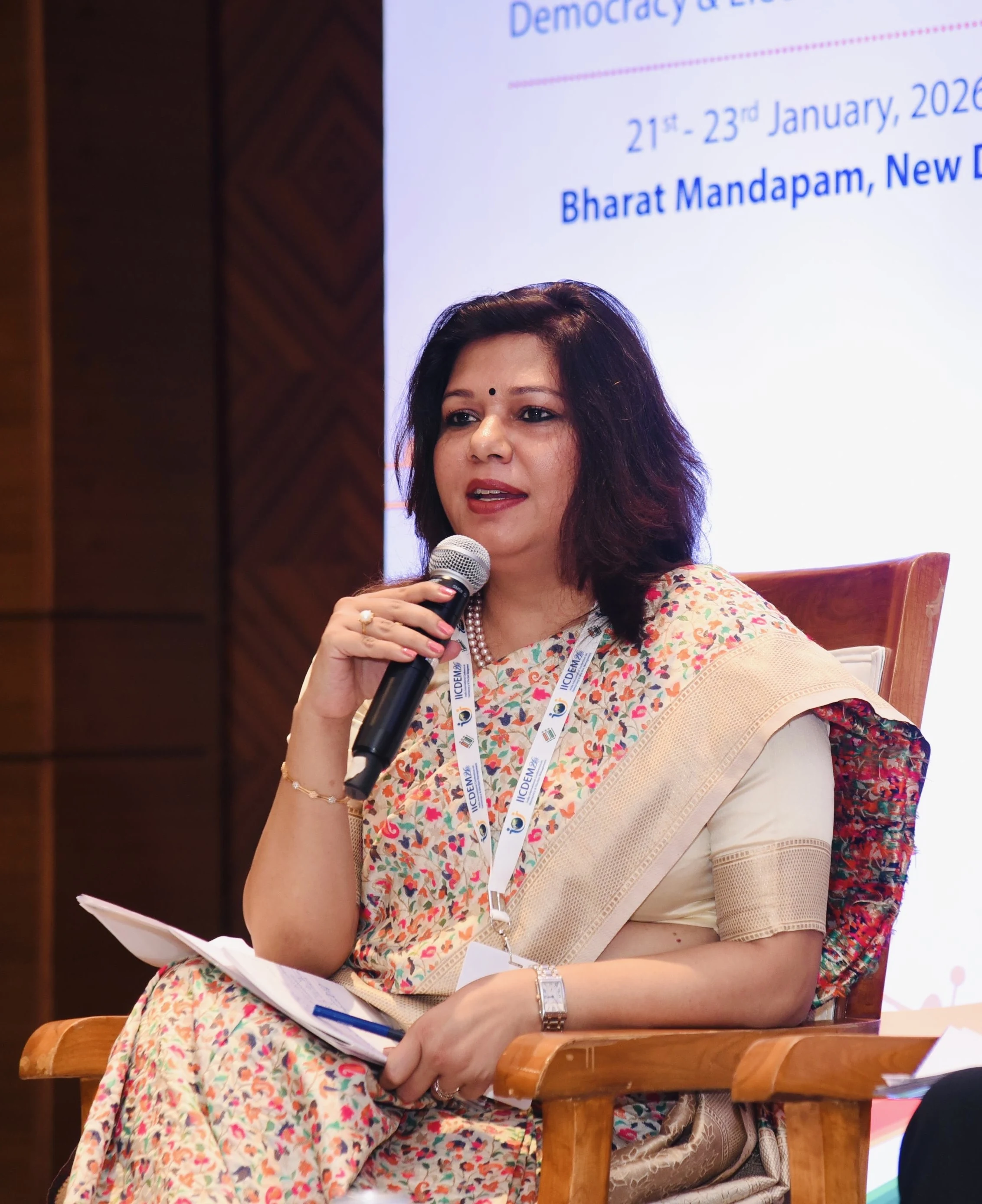 Shubhra Saxena speaking on a panel at a democracy and elections conference